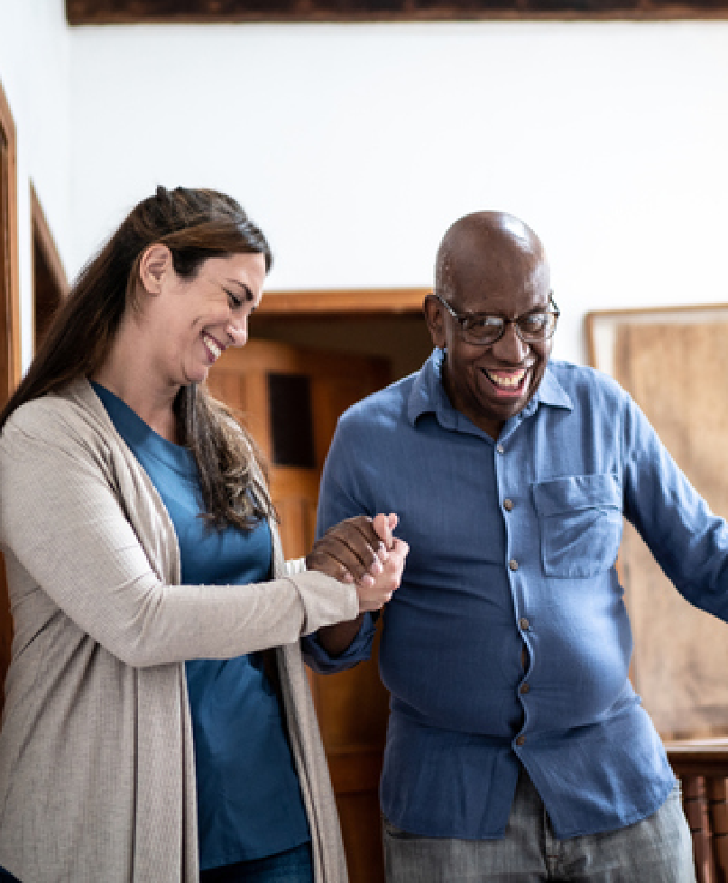 nursing assistant helping a patient walk